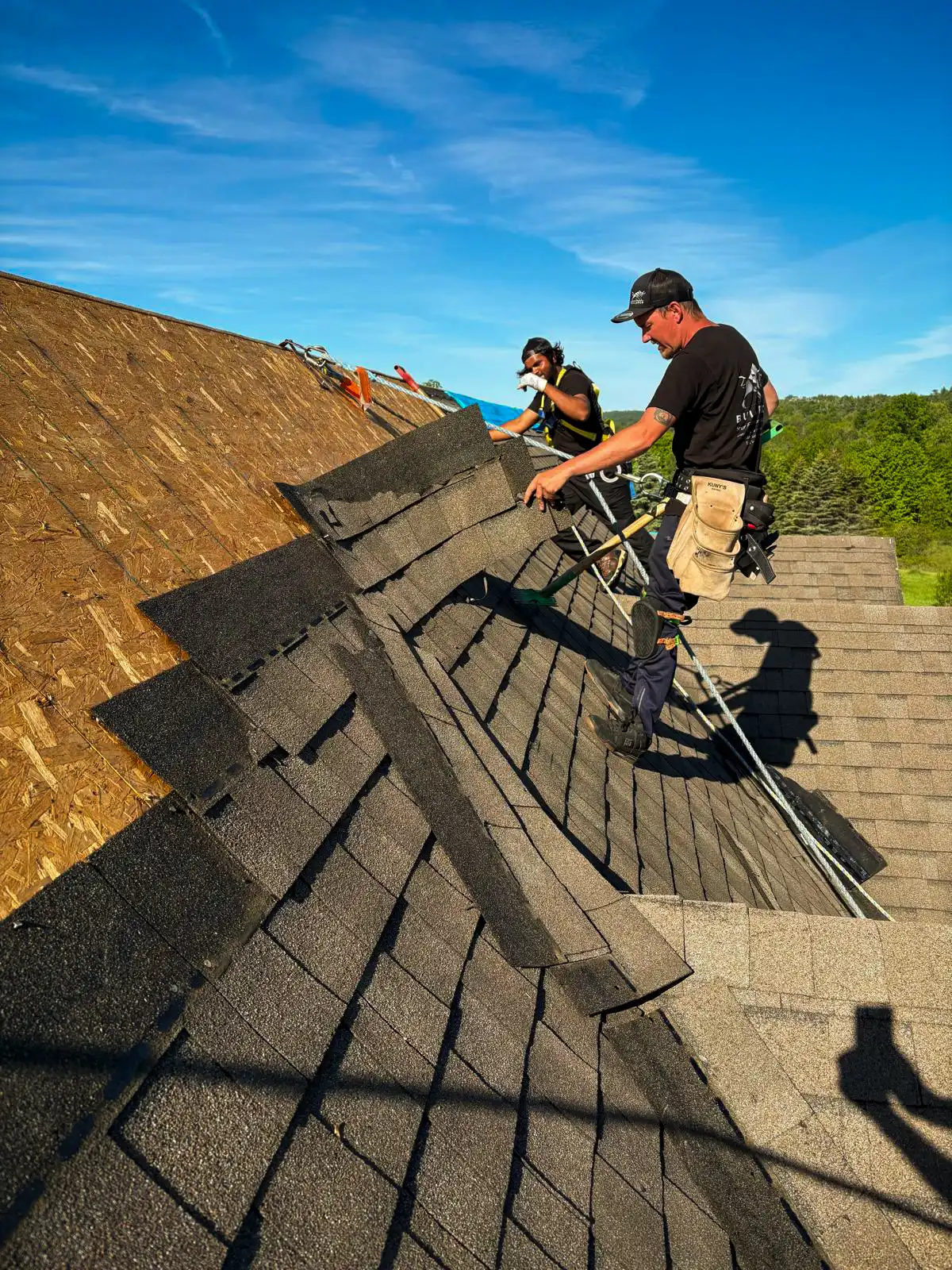 Bullarco crew installing architectural asphalt shingles on a residential roof