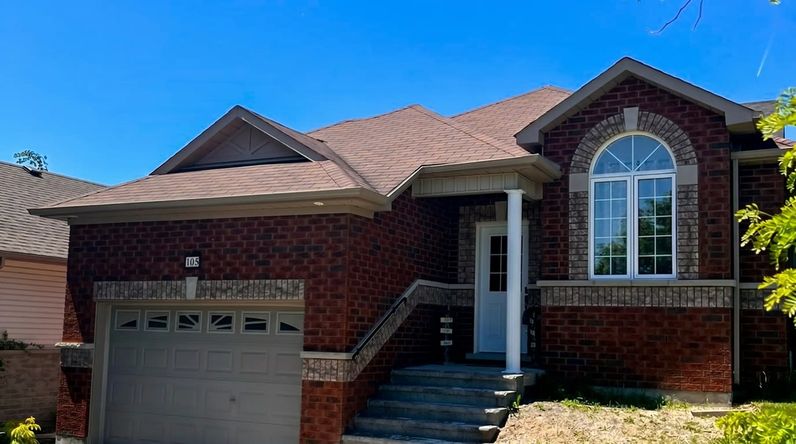 Completed architectural asphalt shingle re-roof on a Peterborough brick bungalow by Bullarco
