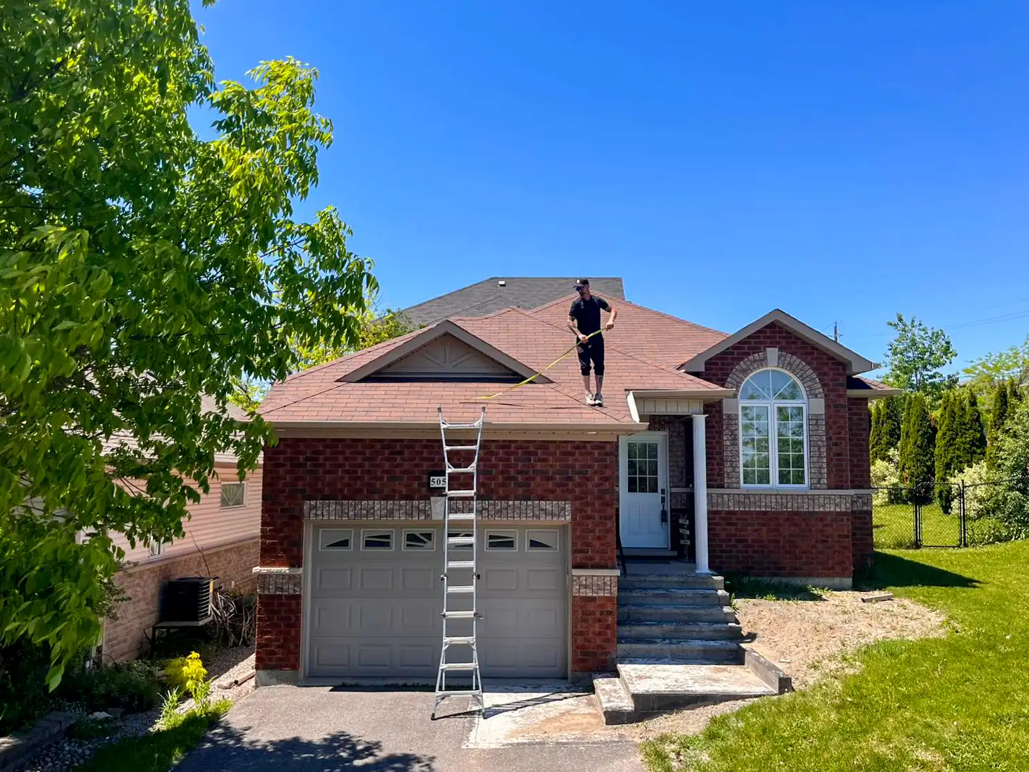 Bullarco crew member on a completed architectural shingle roof, Peterborough area