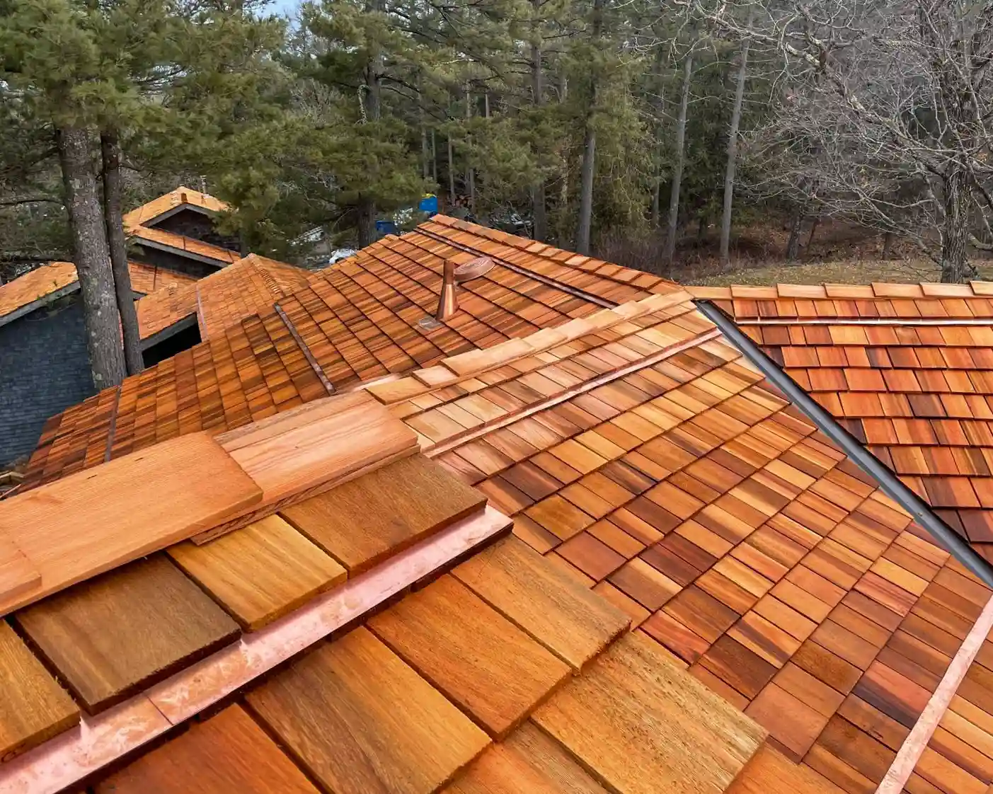 Cedar shingles with copper valley liners installed by Bullarco Roofing